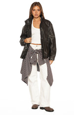 Front view of the brown PU funnel neck jacket, worn open, highlighting its oversized fit and visible stitching