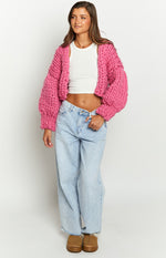Front view of a blossom pink chunky knit cropped cardigan with balloon sleeves
