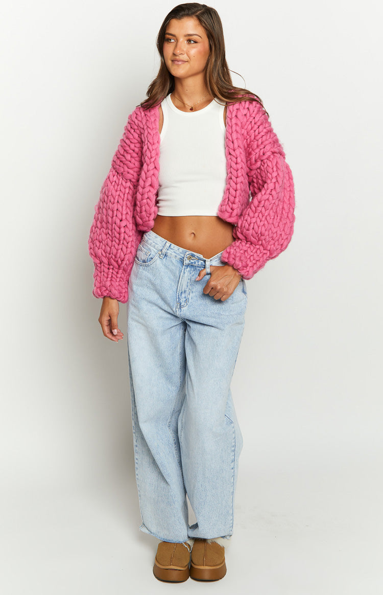 Front view of a blossom pink chunky knit cropped cardigan with balloon sleeves