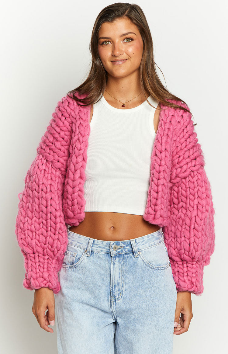 Front view of a cropped blush pink chunky knit cardigan with voluminous balloon sleeves