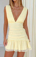 Yellow mini dress with a deep V-neckline, ruched bodice and skirt, and a ruffled hem