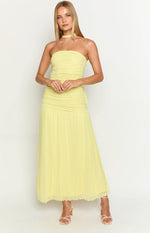 Front view of a yellow strapless maxi dress with a ruched bodice and a flowy pleated skirt