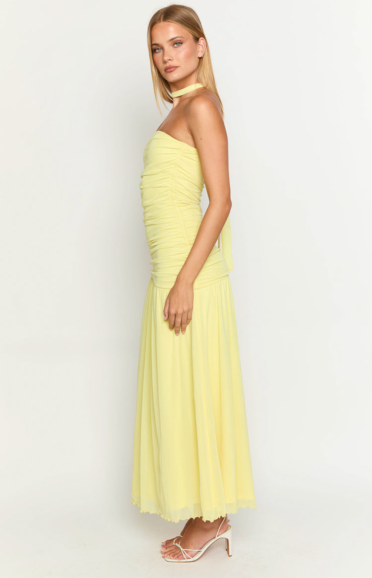 Side view of a yellow strapless ruched maxi dress with a flowy skirt and a choker neck tie