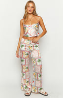 Beginning Boutique Bridget White Satin Roma Print Pants white satin wide-leg pants with a fruit and floral print and elasticated waist