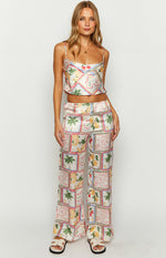 White satin wide-leg pants with an elasticated waist and a tiled Roma print of fruits and palm trees