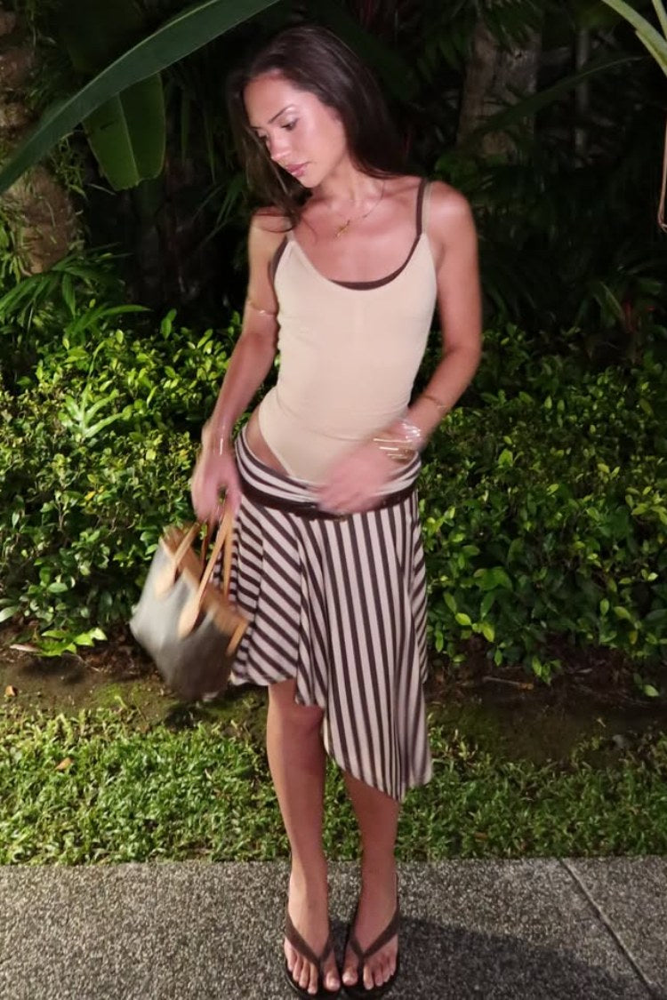Full view of the brown stripe asymmetrical midi skirt with a high-low hem and flowy drape
