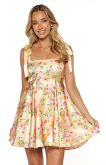Front view of a yellow floral satin mini dress with a square neckline and tie-up shoulder straps