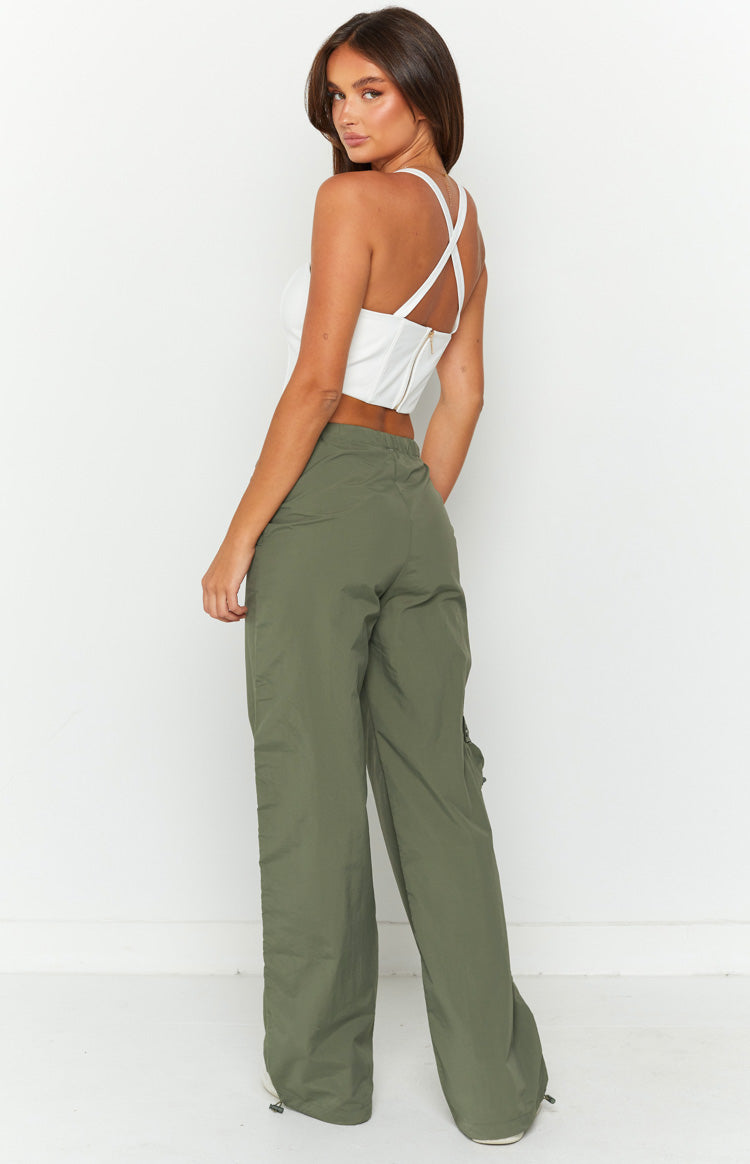 Rear-side view of khaki cargo pants showing the elasticated waist, side pocket, and drawcord ankle hems