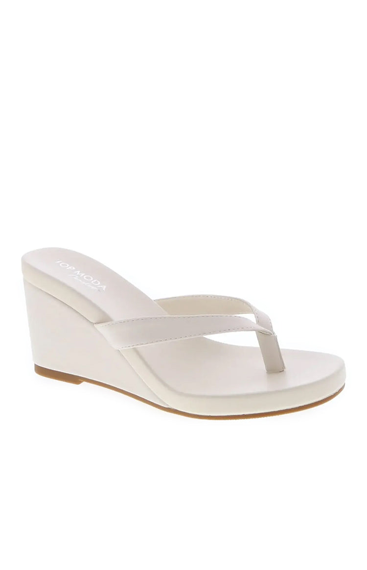 Beginning Boutique Bruna Ivory PU Wedge ivory PU thong strap wedge with a medium heel and tan sole