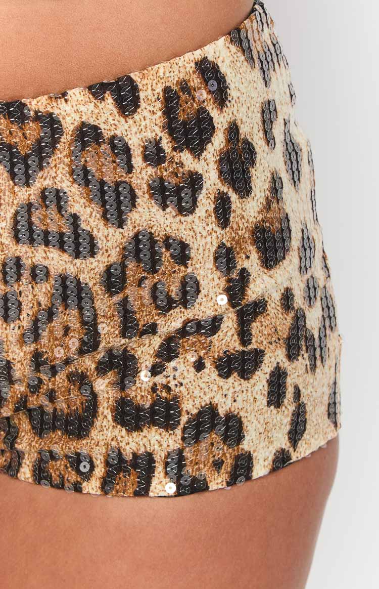 Close-up of the tan and brown leopard print pattern created with shimmering sequins on the micro shorts