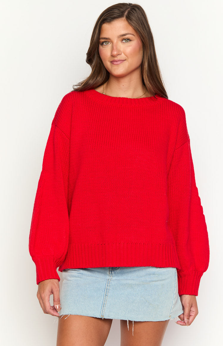 Red knit sweater with a wide boat neck, relaxed fit, and voluminous long sleeves with ribbed cuffs and hem