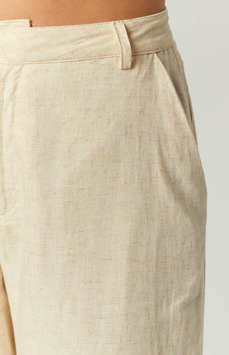 Close-up of the cream linen blend fabric texture with a side pocket and belt loops