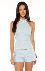 Light blue halter neck button up top with a deep V-neckline and pointed collar, showing the fitted waist