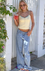 Full length view of light wash low rise jeans with a relaxed wide leg silhouette