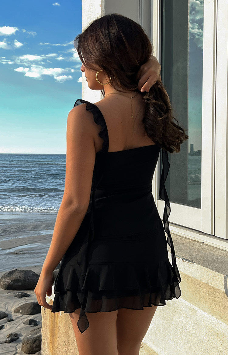 Black chiffon top with twisted bust, open front, ruffled straps, and long sheer flowing panels