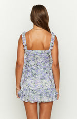 Rear view of a purple floral print chiffon mini skirt with tiered ruffles