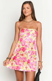 Vibrant yellow and pink floral mini dress with a square neckline, thin spaghetti straps, and a ruched bodice