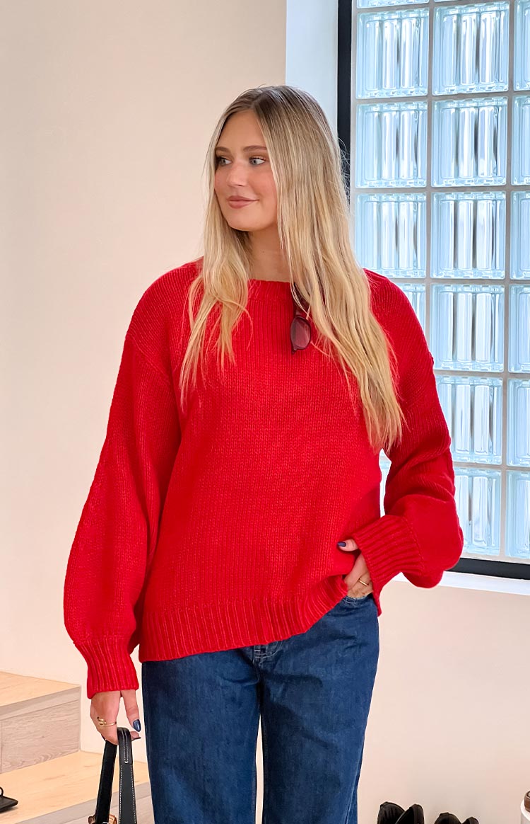 Relaxed fit red knit sweater with a round neck and long balloon sleeves with ribbed cuffs