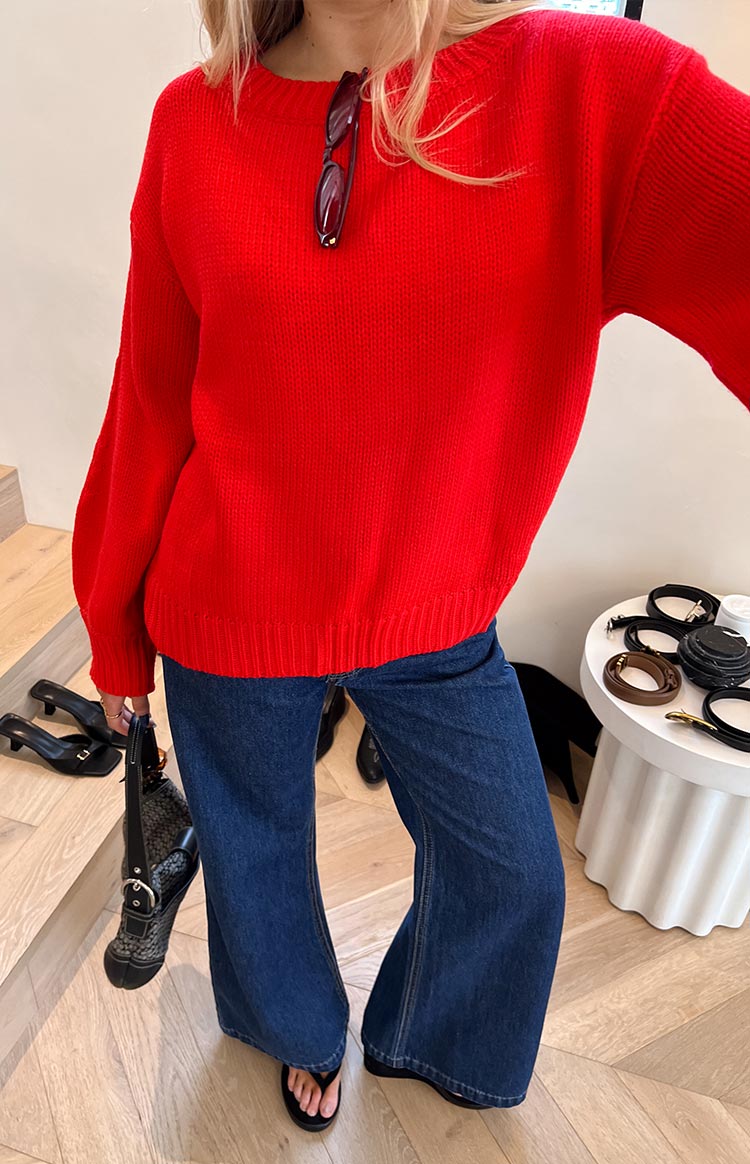 Red knitted sweater with a relaxed fit, crew neck, voluminous long sleeves, and ribbed cuffs and hem