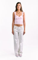 A pair of low-rise wide-leg white denim jeans with contrasting seam stitching.