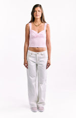 Full length front view of white low waist baggy leg jeans showing the relaxed fit and contrast stitching