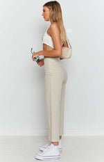 Beige high-waisted straight leg pants with a textured linen-look fabric, side zipper, and cropped length