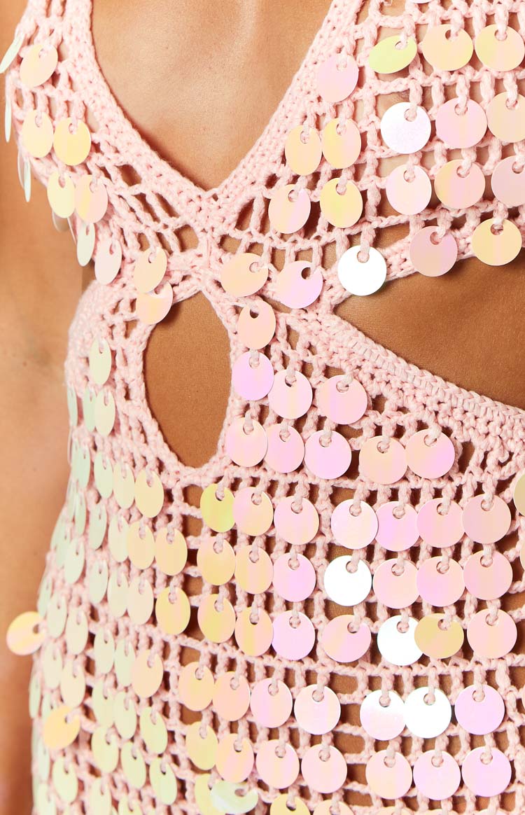 Pink crochet mini dress with iridescent sequins, deep V-neck halter, and side waist cutouts