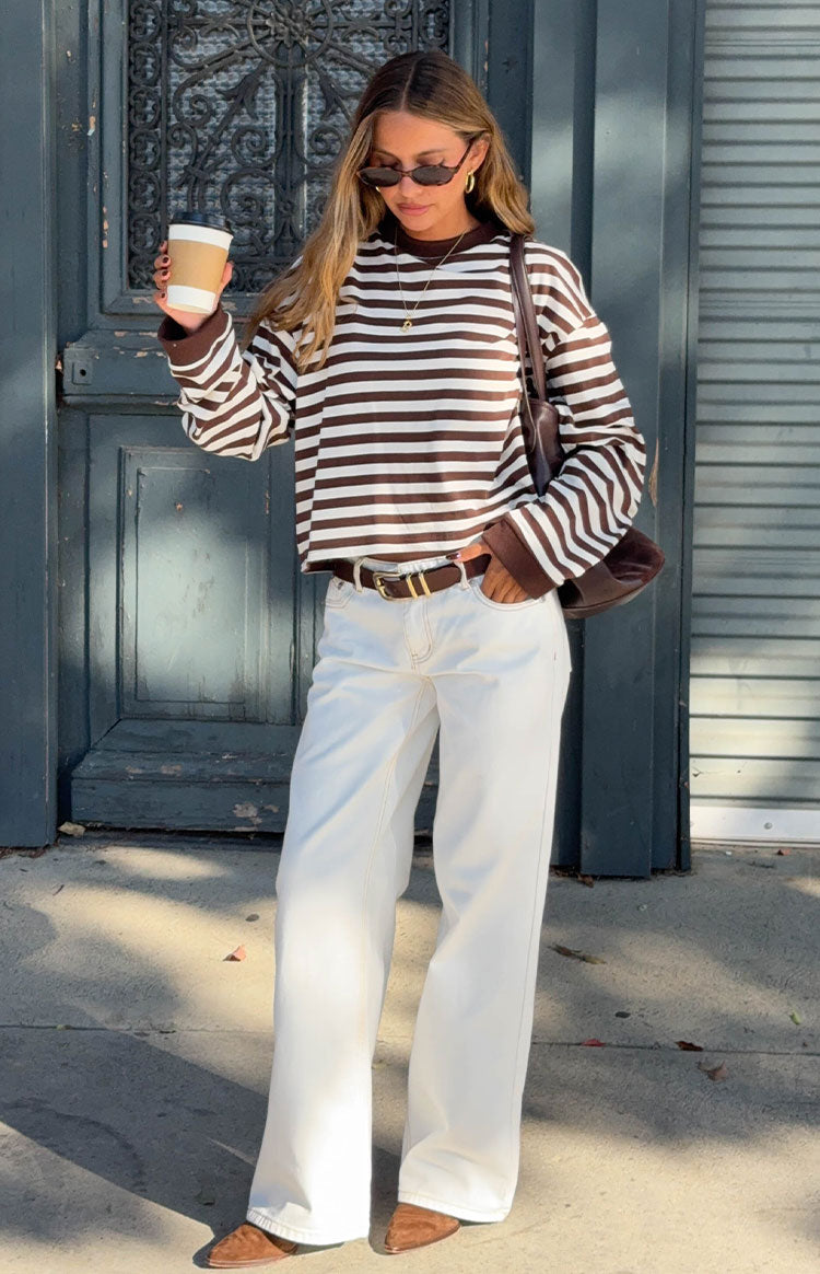 Full length view of white denim low-rise wide-leg jeans with light brown contrast stitching
