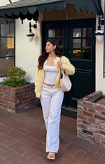 Full length view of white low rise denim jeans with a relaxed wide leg fit