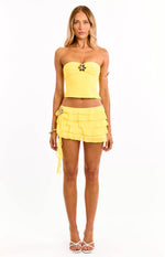 Yellow strapless crop top with a gold hibiscus trim at the center bust
