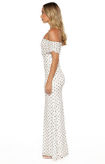 Side view of a white mesh maxi dress with black polka dots, off-shoulder neckline, and ruched short sleeves
