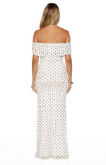 Rear view of a white mesh maxi dress with black polka dots and an off-shoulder ruched neckline