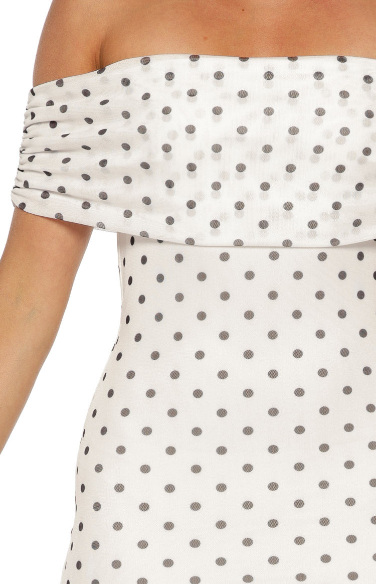 Close-up of the white mesh off-shoulder neckline with ruched detail and black polka dots on the maxi dress