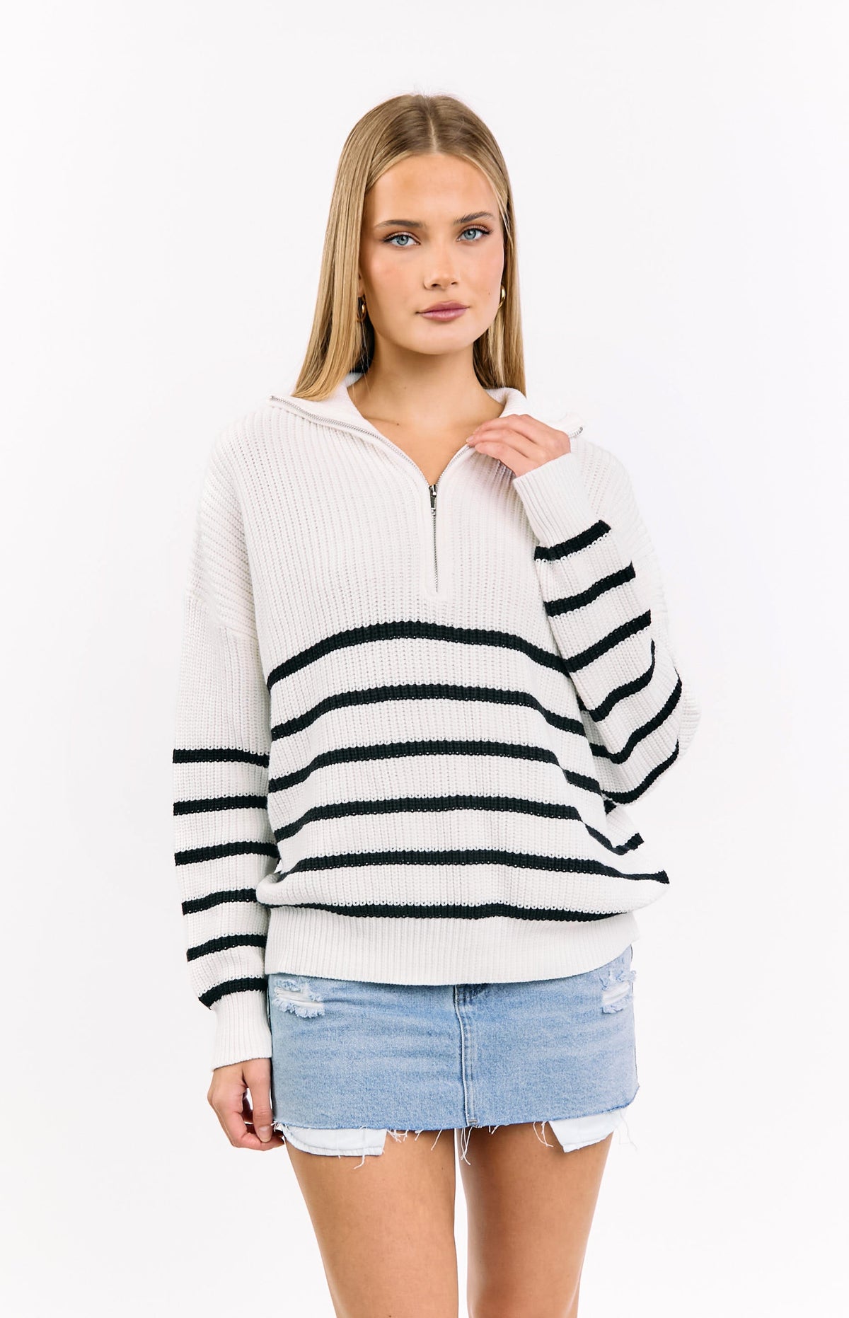 Front view of a cream knit jumper with black horizontal stripes and a quarter zip collar, relaxed fit