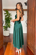 Side view of a green satin maxi dress with ruffled shoulder straps and a flowy A-line skirt