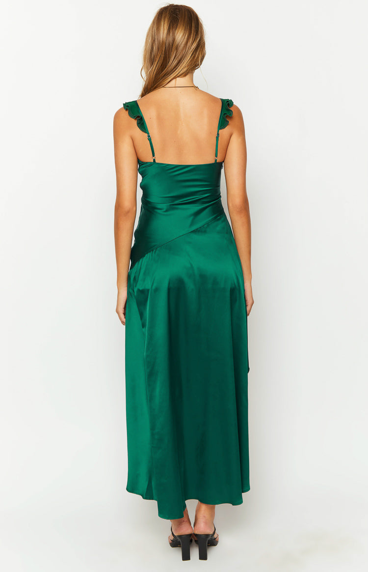 Rear view of a green satin maxi dress with ruffled spaghetti straps and a diagonal seam detail on the flowy skirt