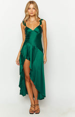 Emerald green satin maxi dress with V-neck, ruffled straps, and asymmetrical ruffled skirt with high slit