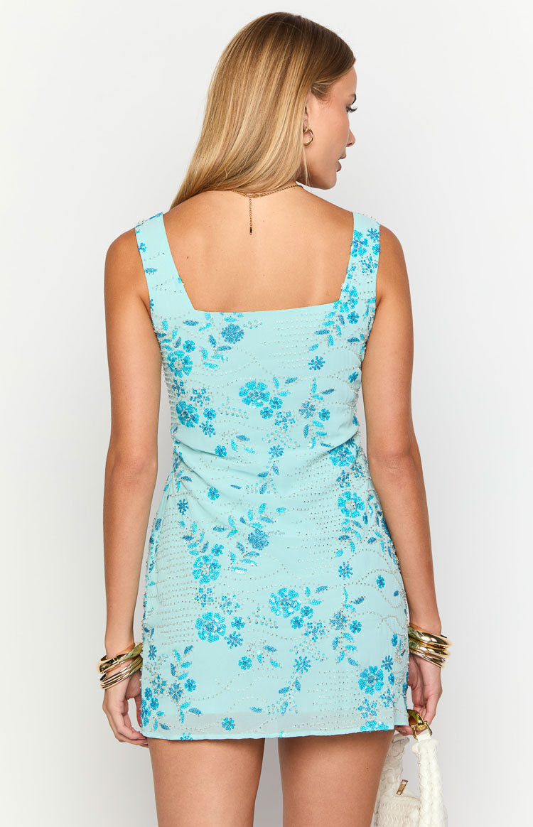 Rear view of a light blue beaded mini dress with a square neckline and blue floral pattern