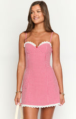 Red and white gingham mini dress with sweetheart neckline, white lace trim, red bow, and lace hem