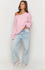 Light pink chunky knit sweater with an oversized fit, wide off-shoulder neckline, and voluminous balloon sleeves