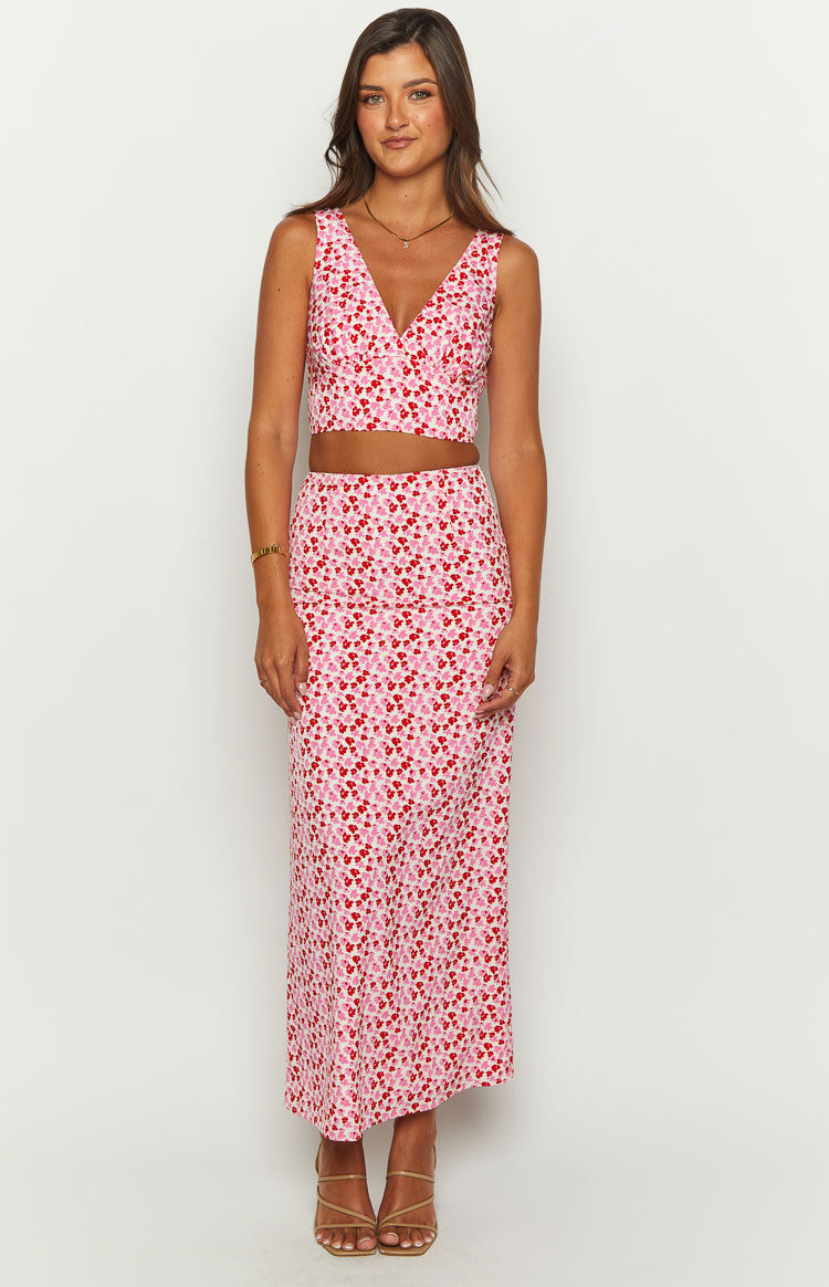 Front view of a pink and red speckled crop top with a deep V-neck and wide sleeveless cut