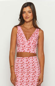Front view of a pink and red speckled crop top with a deep V-neckline and sleeveless design