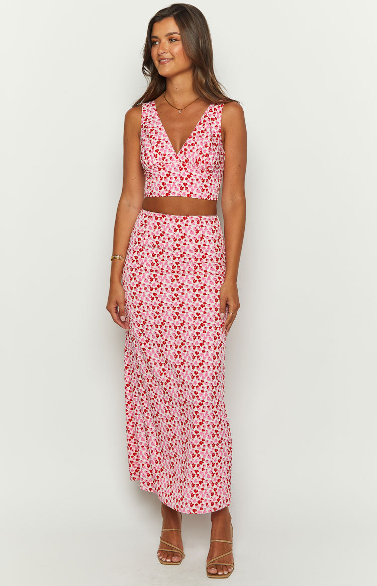 Front view of a deep V-neck pink and red speckled sleeveless crop top with a fitted bodice