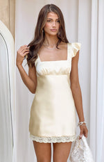 Yellow satin mini dress with a square neckline, ruffled cap sleeves, empire waist, and lace trim
