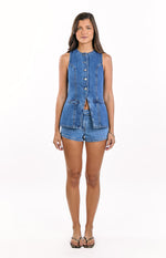 Front view of a mid-wash denim vest top with a band collar, gold button-down front, and two waist flap pockets