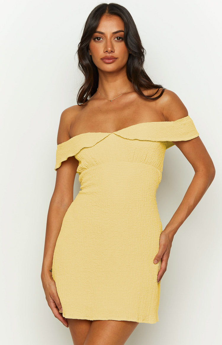 Close-up of the textured yellow off-shoulder mini dress with a sweetheart neckline and gathered bodice