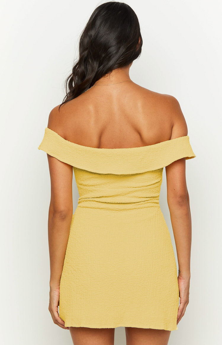 Rear view of a yellow textured off-shoulder mini dress with a folded neckline band
