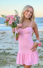 Pink crepe mini dress with a ruched sweetheart bust, thin spaghetti straps, and a ruffled hem