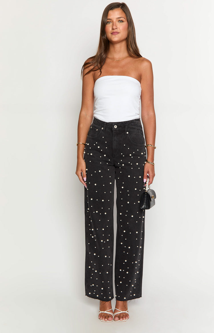 Black high waisted straight leg jeans with scattered pearl embellishments and a raw frayed hem