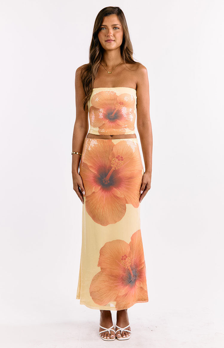 Front view of the yellow sequin maxi skirt with large orange hibiscus flowers and a straight silhouette
